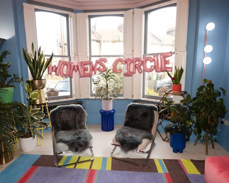 The Women's Circle balloon banner strung across the window of the Circle 1.0 venue