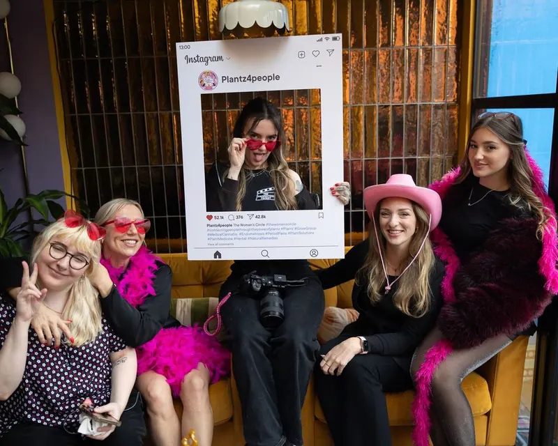 Women's Circle guests playing with a giant Instagram photo frame