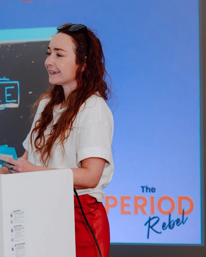 Charlotte, The Period Rebel, speaking on stage at Circle 2.0