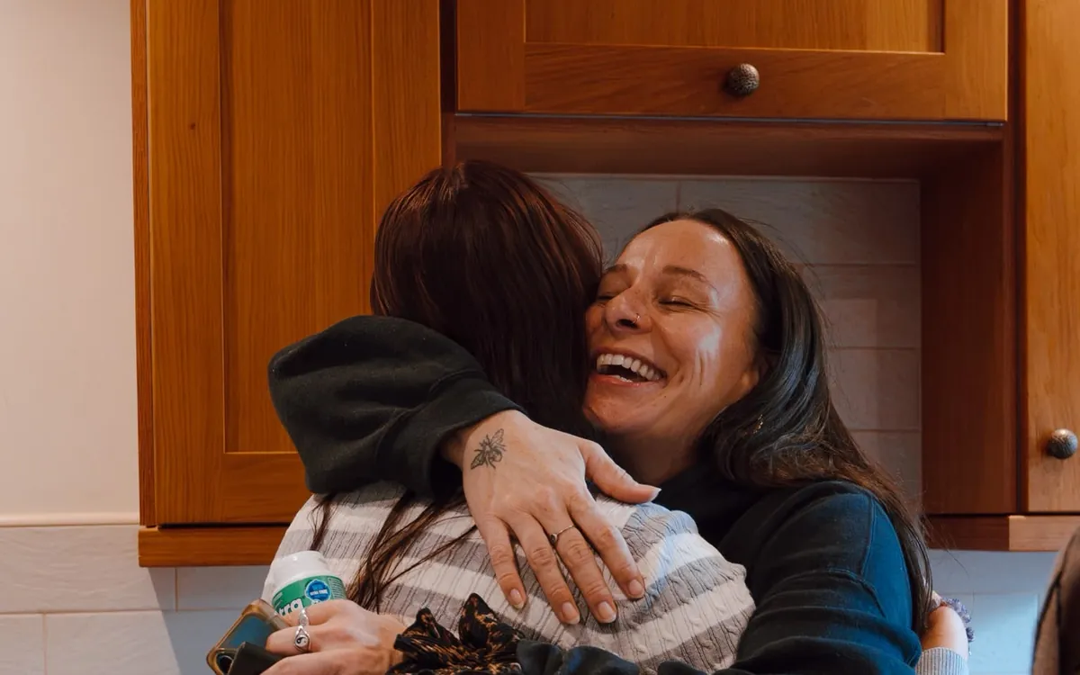 Two women sharing a big, happy hug at Circle 2.0
