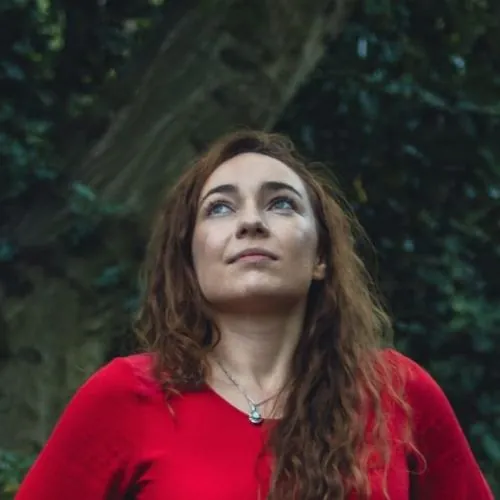 Charlotte, Menstrual Health Practitioner and owner of The Period Rebel, headshot in a forest setting